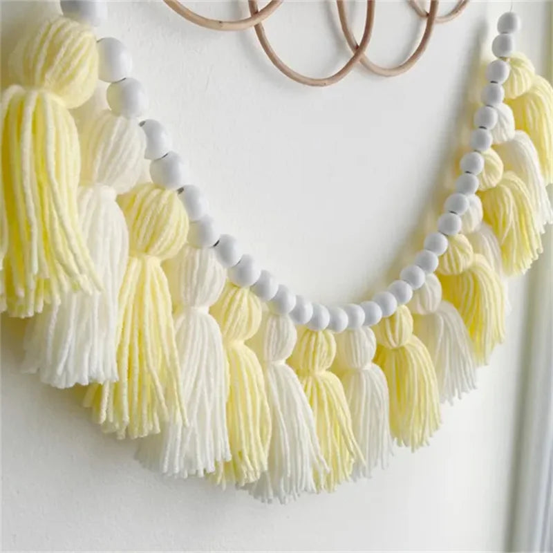 Yellow boho tassel garland wall decor with multiple strands.