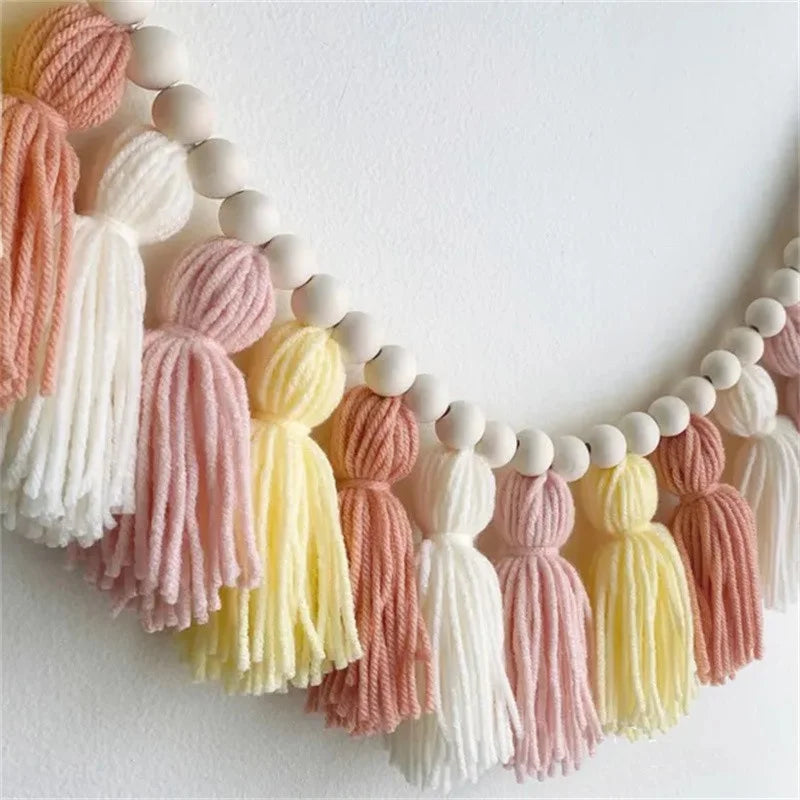 Yellow boho tassel garland wall decor with multicolor tassels hanging.