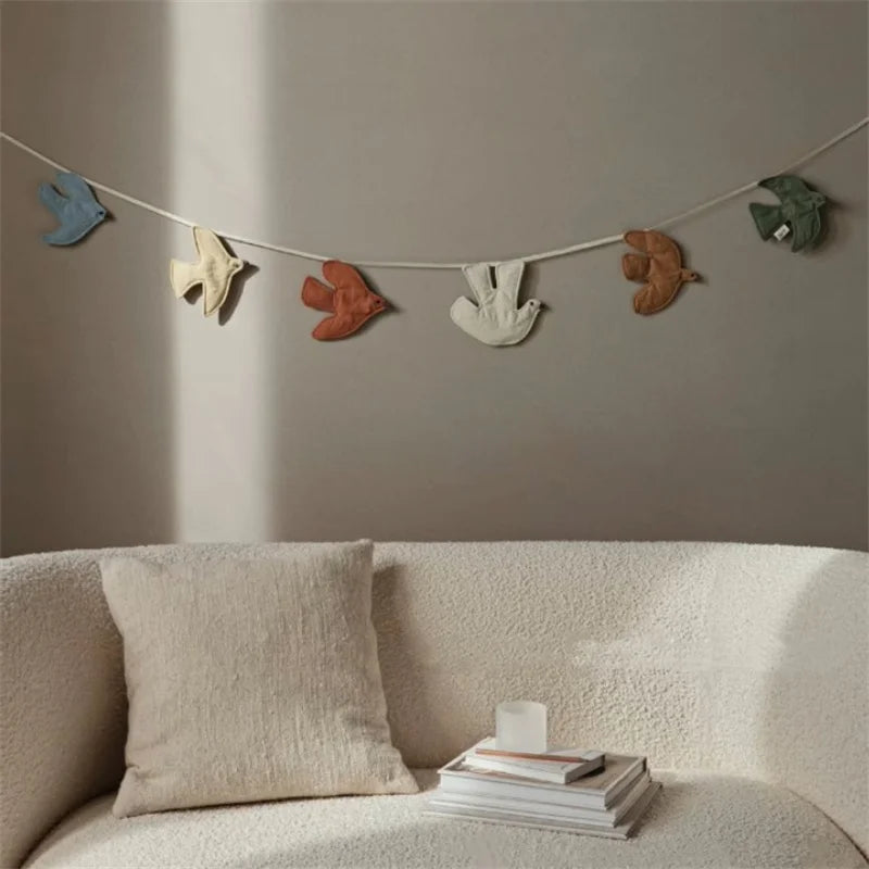 Colorful Nordic fabric bird hanging ornaments on a wall, Scandinavian-inspired decor for modern interiors