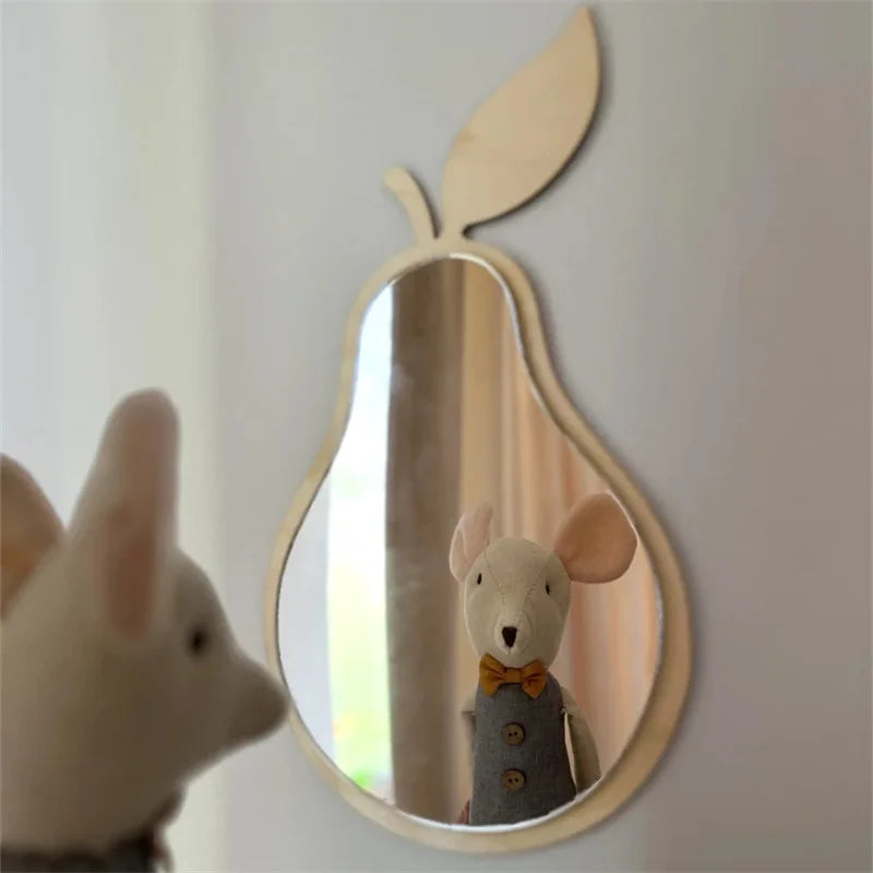 Handmade Scandinavian wood pear mirror with minimalist wooden frame and shatter-resistant surface hanging on wall