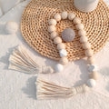 Nordic wooden bead garland with white tassels hanging on wall, 75cm Scandinavian decor