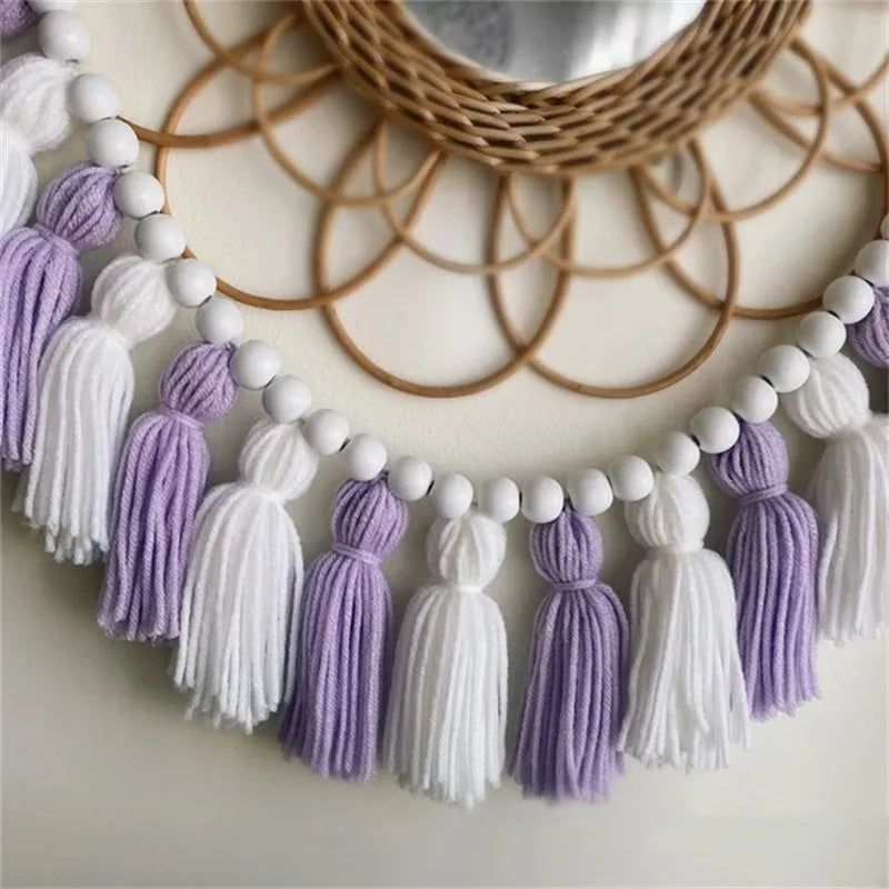 Yellow boho tassel garland wall decor with multiple strands.