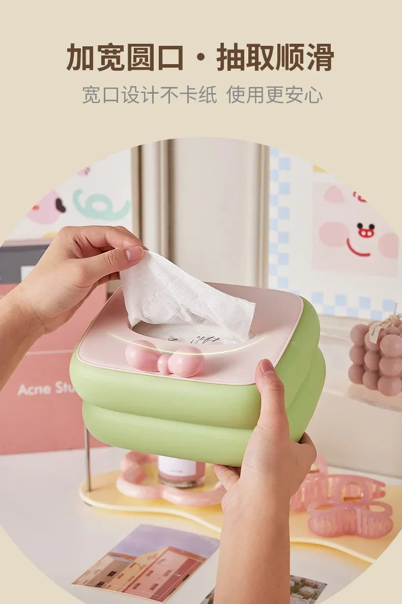 Cute desktop tissue box with spring automatic lift and large capacity storage.