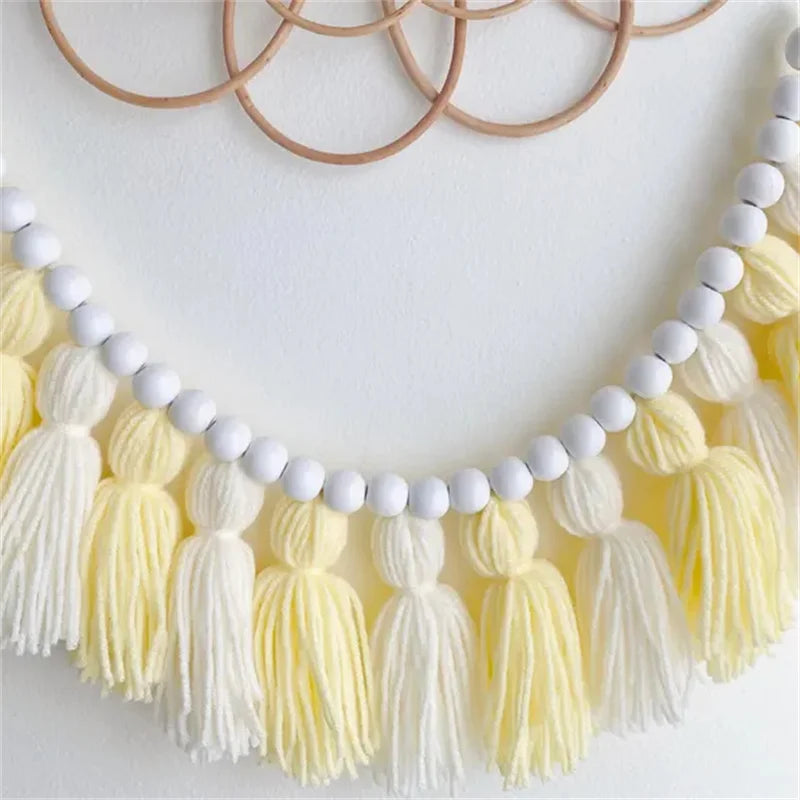 Yellow boho tassel garland wall decor with multiple tassels.